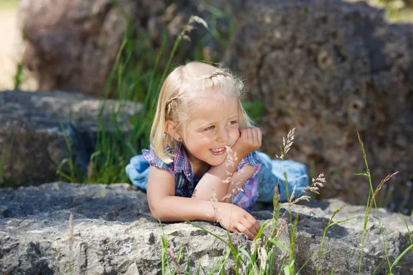 Little girl enjoys a warm rock — Stock Photo, Image