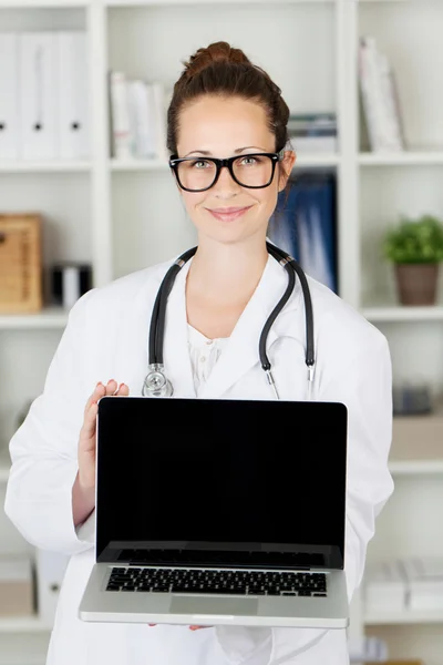 Young female doctor with a blank laptop — Stock Photo, Image