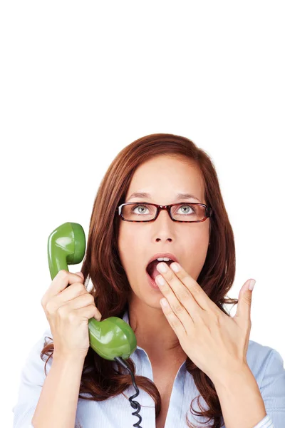 Bored woman holding a telephone handset — Stock Photo, Image