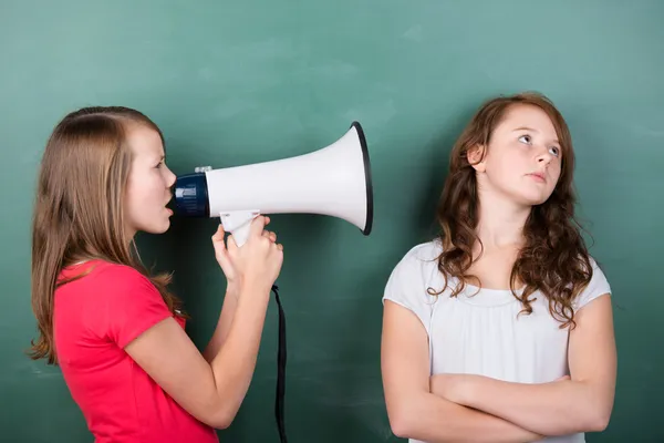 Girl trying to make herself heard with a megaphone — Stock Photo, Image