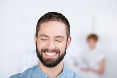 Young Man Laughing With His Eyes Closed clipart