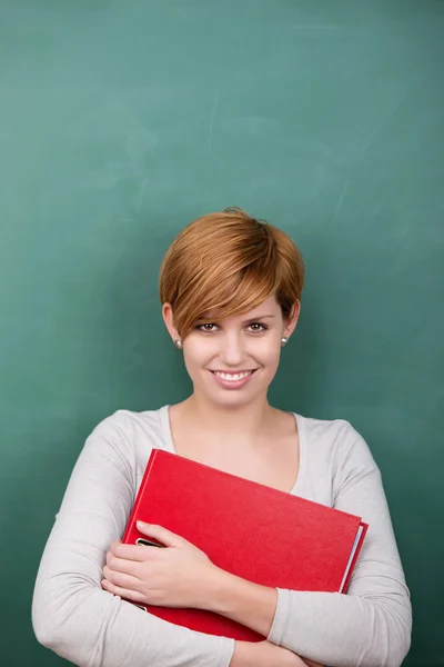 Female Professor Holding File Against Chalkboard — Stock Photo, Image