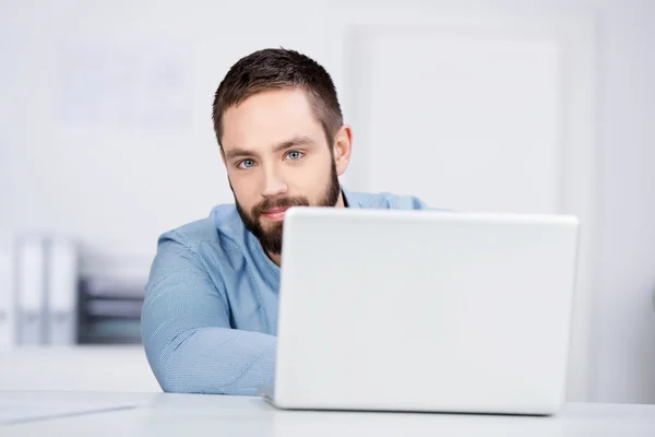 Zakenman met laptop aan balie — Stockfoto