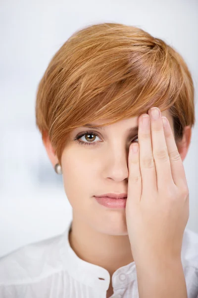 Empresaria cubriendo su ojo con la mano — Foto de Stock