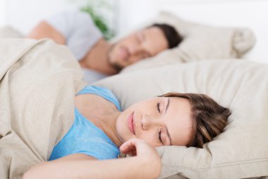 Young couple sleeping in bed clipart