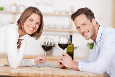 Smiling couple drink red wine clipart