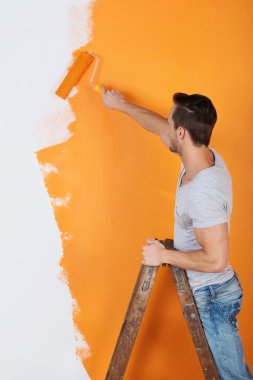 Man is working with paint roller clipart