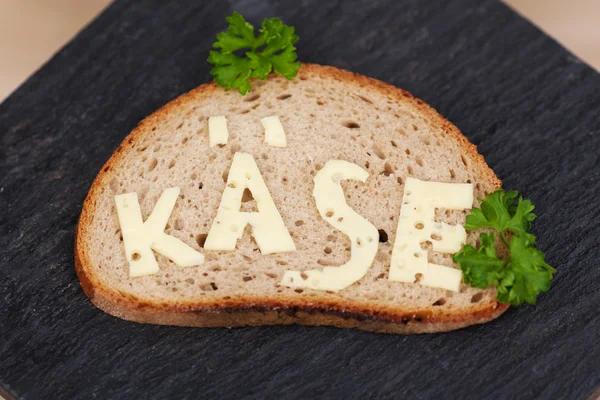 Slice of bread with the Cheese word over a stone — Stock Photo, Image