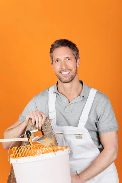 Happy Painter Against Orange Painted Wall — Stock Photo, Image