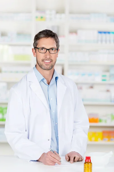Male Pharmacist At Pharmacy Counter — Stock Photo, Image