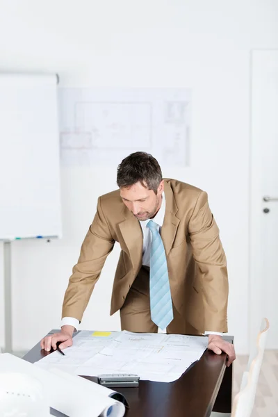 Arquiteto masculino trabalhando na impressão azul na mesa — Fotografia de Stock