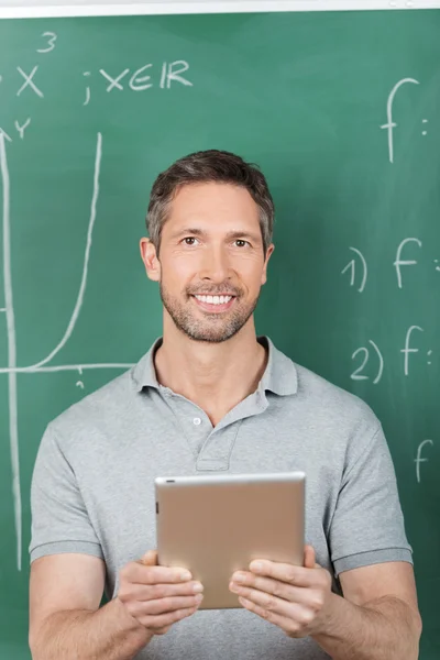 Smiling Male Teacher Holding Digital Tablet Stock Photo