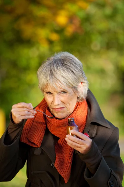 Senior Woman With Syrup At Park — Stock Photo, Image
