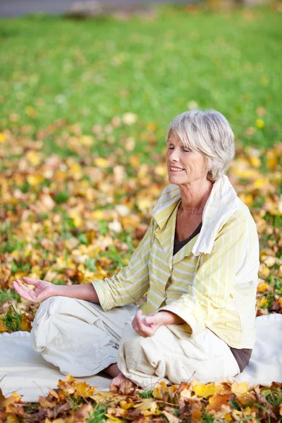 Kobieta medytująca w pozycji lotosu — Zdjęcie stockowe