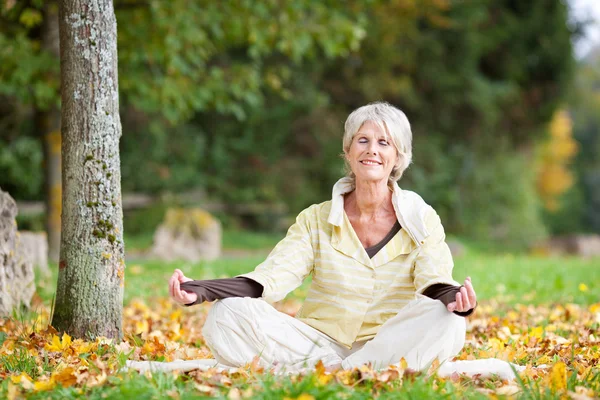 Senior Woman Meditating In Lotus Position — Stock Photo, Image