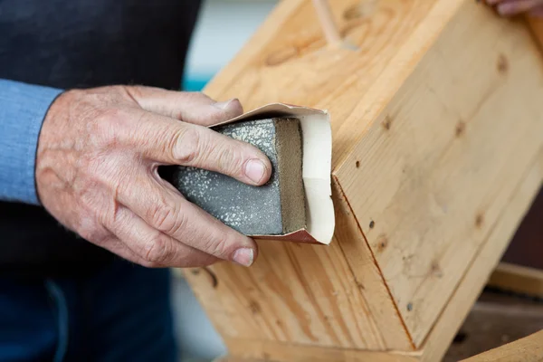 Using Sandpaper For Polishing Birdhouse At Workta — Stock Image Using Sandpaper For Polishing Birdhouse At Workta Royalty Free Stock Photos