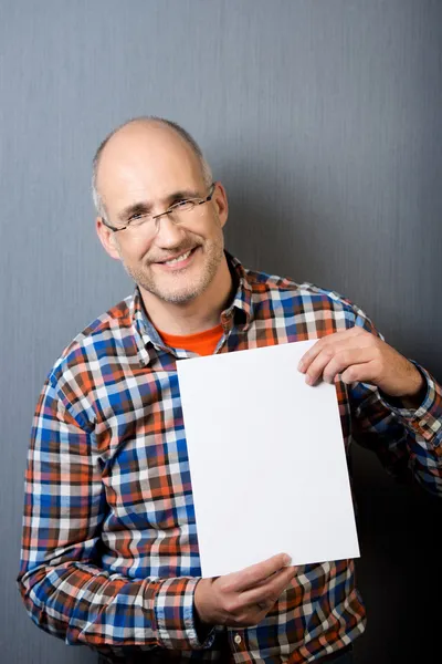 Businessman Holding Blank Placard Against Gray Wall — Stock Photo, Image