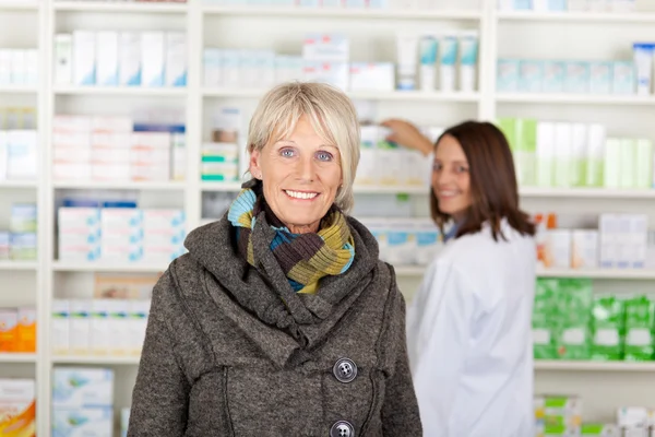 Senior with a scarf in the pharmacy — Stock Photo, Image