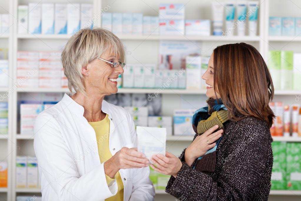 Pharmacist giving medication — Stock Photo © racorn 26988113