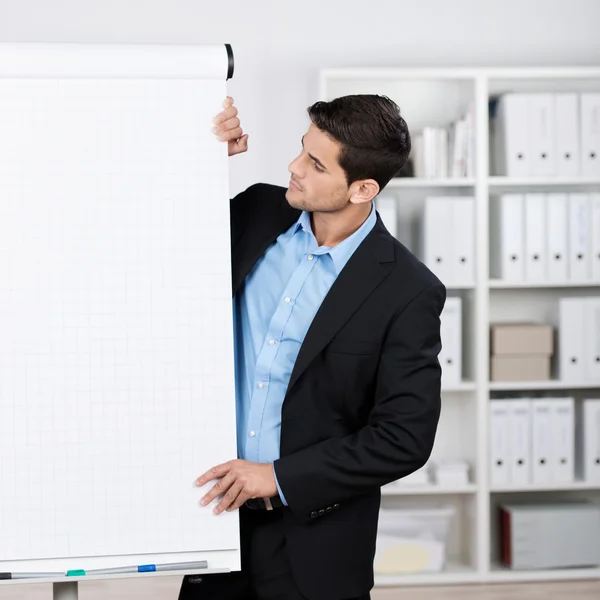 Businessman wearing suit looking at flipchart — Stock Photo, Image