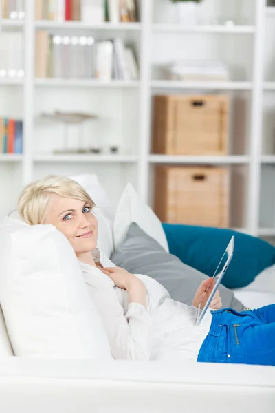 Blond girl with digital pad at home — Stock Photo, Image