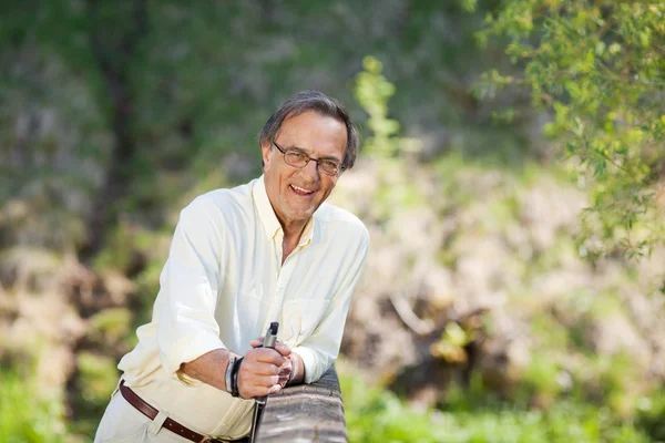 Elderly man talking a break during nordic walking — Stock Photo, Image