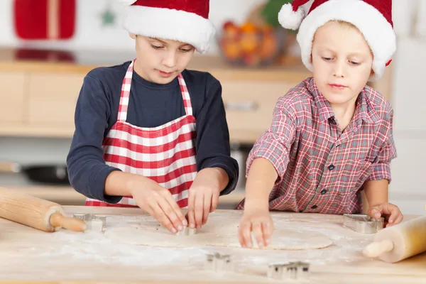 Brothers Using Cutters On Dough to Make Christmas Cookie — стоковое фото