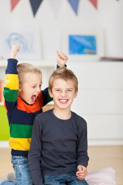 Young Boy With Wild Brother Raising Arms — Stockfoto