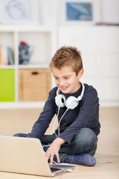 Browsing young boy with headphones — Stock Photo, Image
