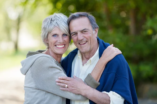 Senior Couple Embracing In Park Royalty Free Stock Photos