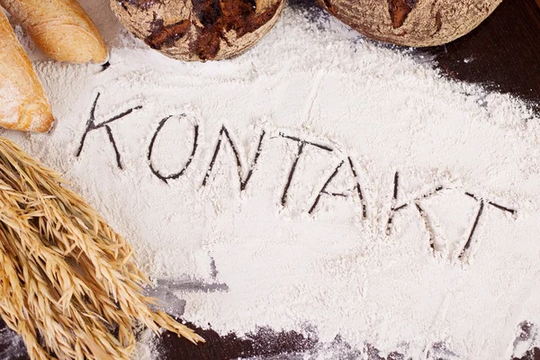 Kontakt, written in flour — Stock Photo, Image