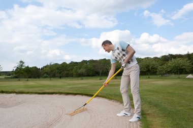 golfer racking sand clipart