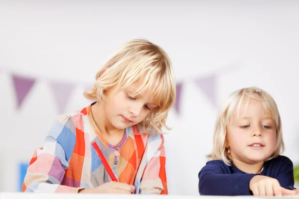 Two young sisters drawing pictures together — Stock Photo, Image