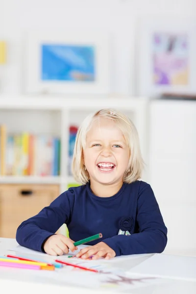 Happy small young girl laughing in kindergarten — Stock Photo, Image