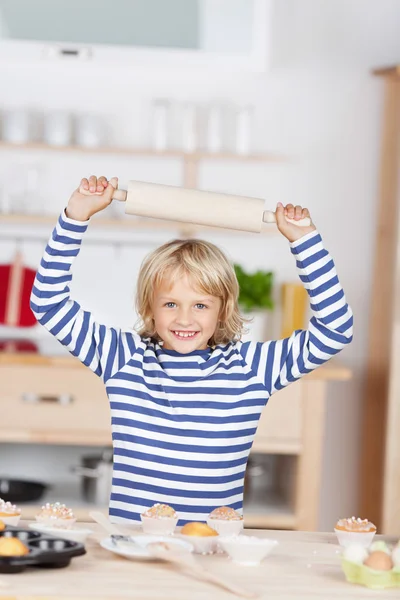 Smiling little girl with a rolling pin — Stock Photo, Image