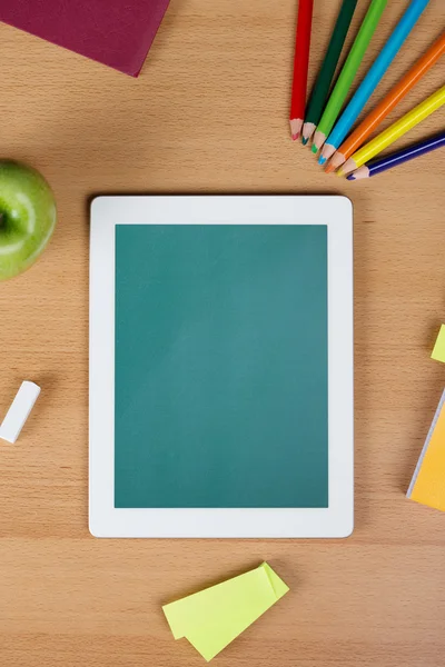 Digital tablet over a school desk — Stock Photo, Image