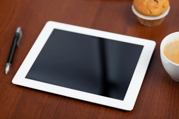 Tablet with an empty screen laid on a table — Stock Photo, Image