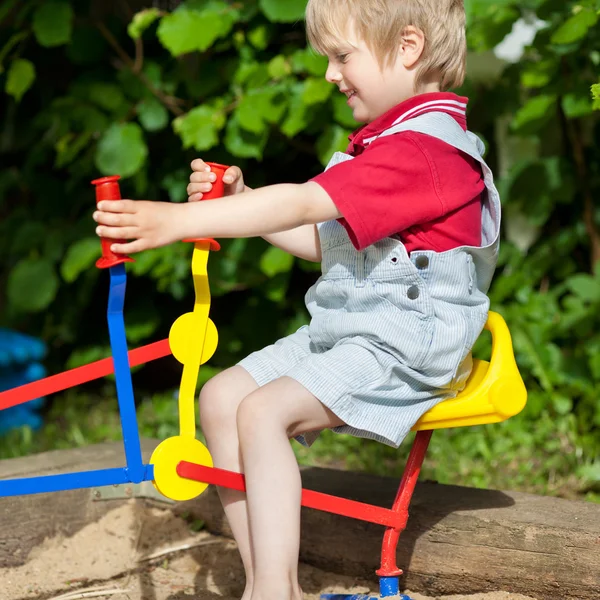 Boy Using Sand Shovel In Playground — Stock Photo, Image