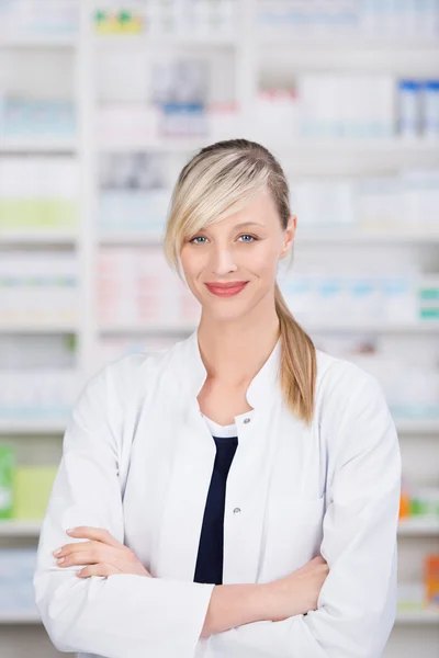 Friendly female pharmacist with crossed arms — Stock Photo, Image