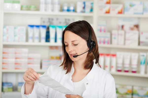 Pharmacist Conversing On Headset In Pharmacy — Stock Photo, Image