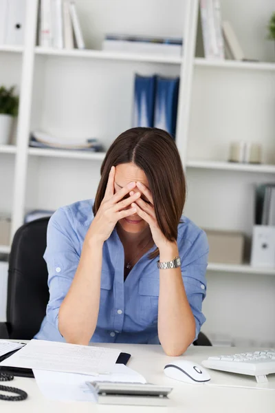 Sad Businesswoman Sitting At Desk Royalty Free Stock Images