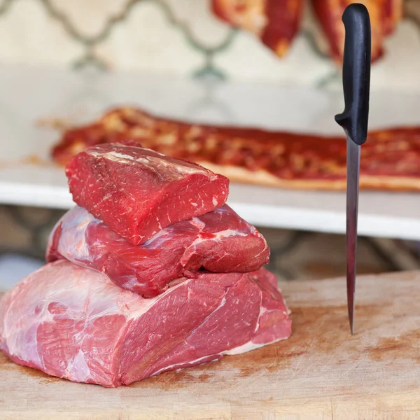 Meat and knife at butcheries table — Stock Photo, Image