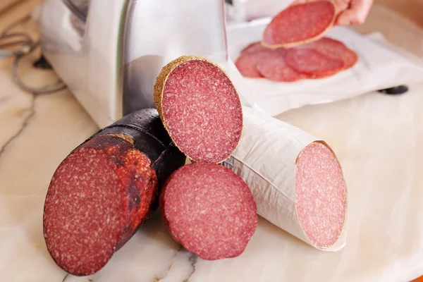 Meat With Machine And Salamis In Background — Stock Photo, Image