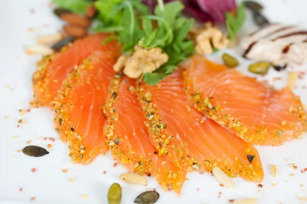 Slices of salmon with walnuts — Stock Photo, Image