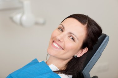 Female Patient Smiling In Dentistry clipart