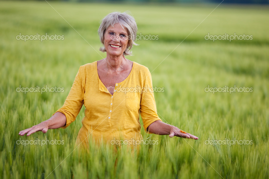 Portrait of woman touching grass Stock Photo - Alamy