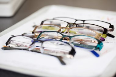 various eyeglasses lying on a tray clipart