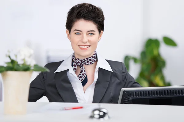 Confident Receptionist Smiling At Counter — Stock Photo, Image