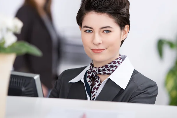 Confident Young Receptionist At Reception — Stock Photo, Image