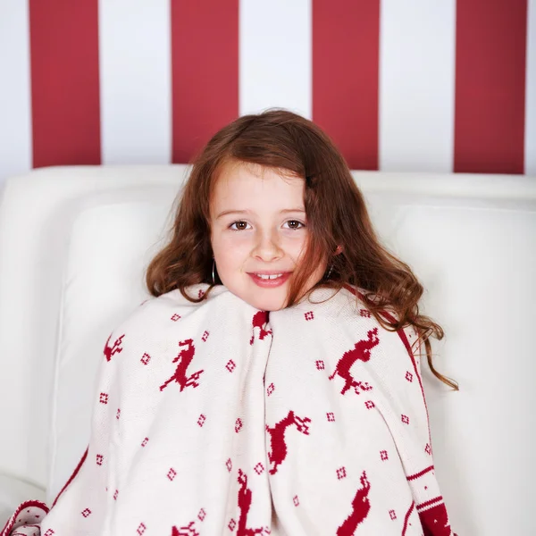 Pretty little girl wrapped in Christmas cloth — Stock Photo, Image